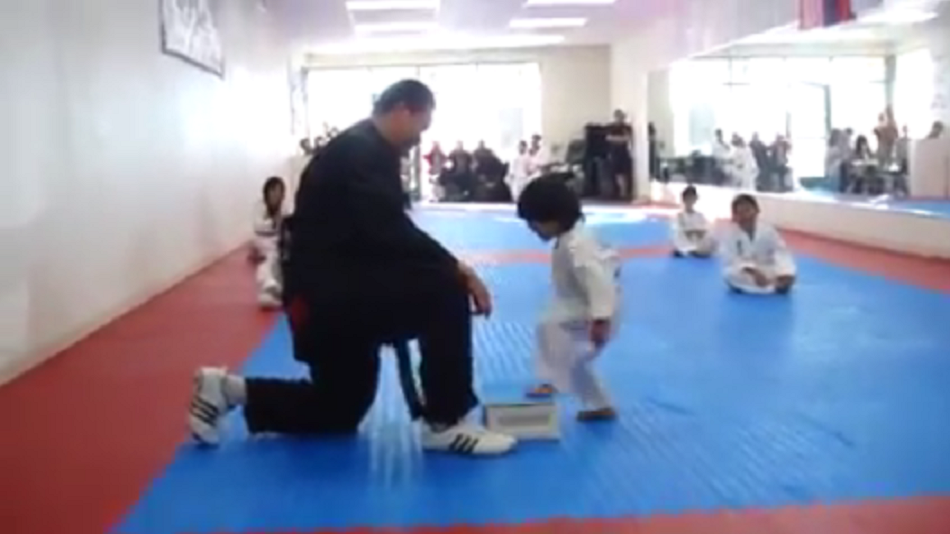 Watch little kid earn belt after learning to break board in Taekwondo