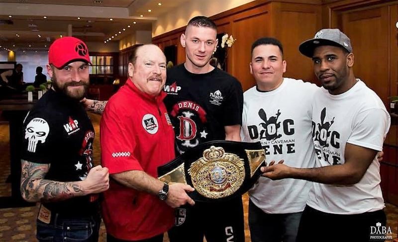 Hall of Fame referee Steve Smoger holding IBA world title belt with interested fighters