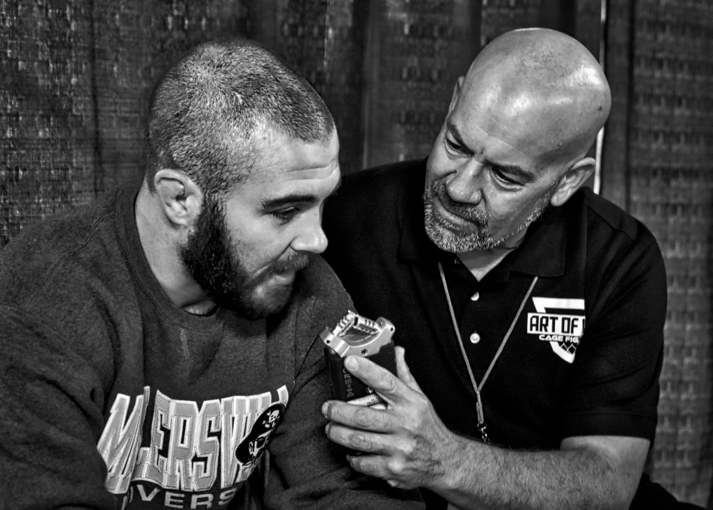 John Brennan speaks with Bob Meloni - Photo by Jamie McDonald for Art of War Cage Fighting.
