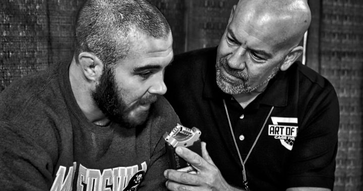 John Brennan speaks with Bob Meloni - Photo by Jamie McDonald for Art of War Cage Fighting.