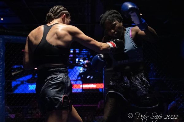 Mia Inzirilo connects with a right hand to the chin of Sharneka Wright Photo captured by Peter Scifo