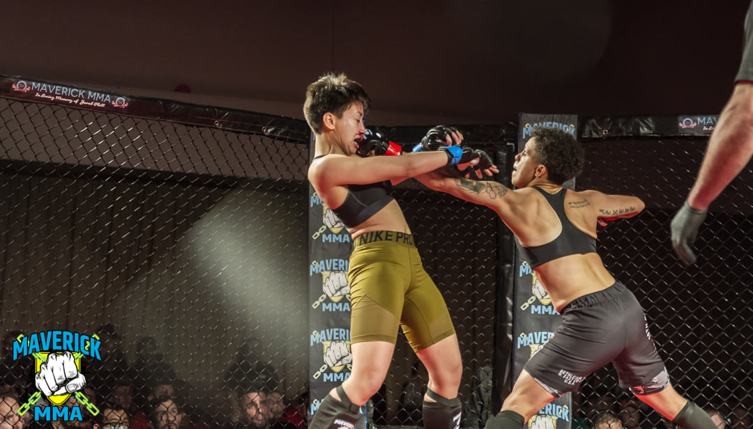 Kali Zervos (left) on the receiving end of punches from Jani Rosario (right) at Maverick 18 - Photo by William McKee