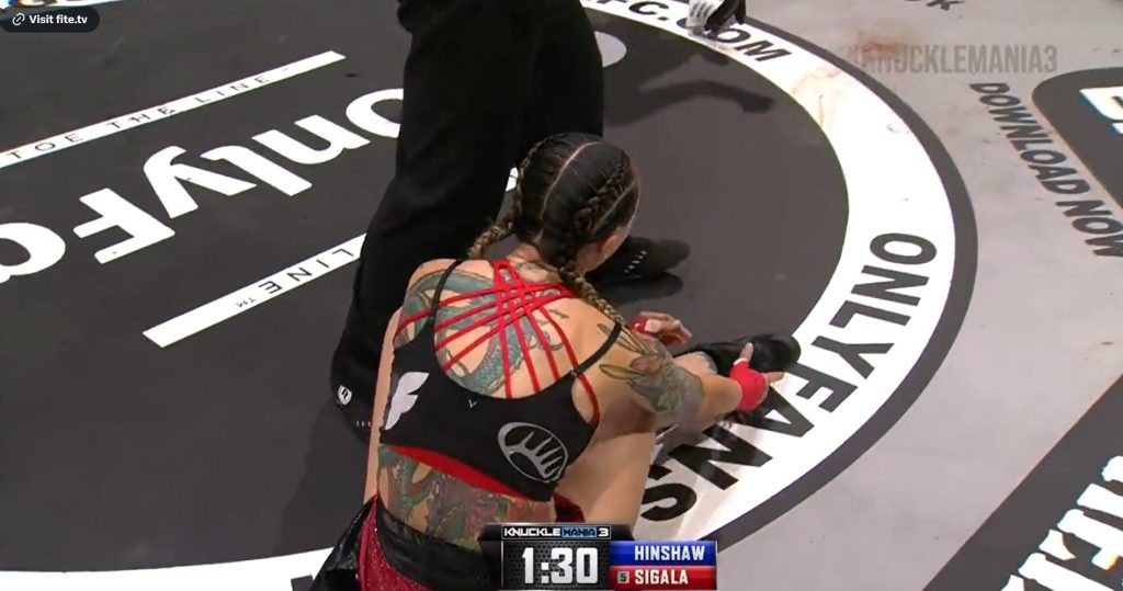Charisa Sigala resets her leg after injury at KnuckleMania 3