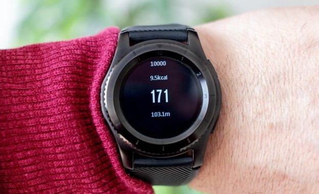 Man examining fitness bracelet, checking calories burned, burn caloriies