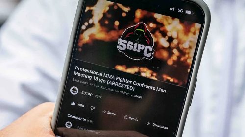 Phone screen showing a YouTube video titled 'Professional MMA Fighter Confronts Man Meeting 13 y/o (ARRESTED)' with 2.1M views and the channel 561PC, on a dark thumbnail backdrop.