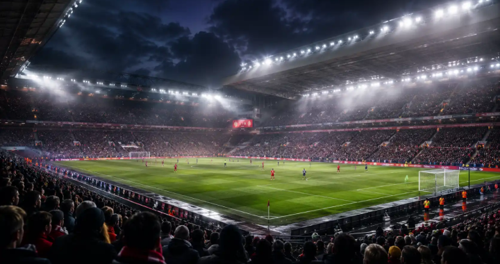 Nighttime soccer match in a full stadium; players on the well-lit field as fans fill the stands.