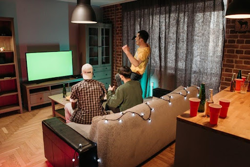 Friends watching an MMA fight night at home in Canada, combat-sport fans